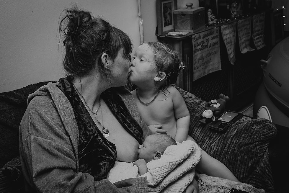 little boy with his mother and newborn brother breastfeeding