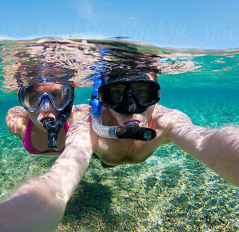 Family snorkeling tour in Cancun with tropical fish and clear Caribbean water