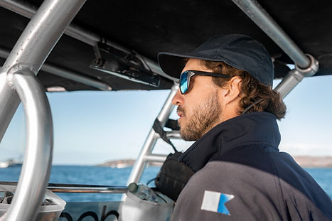 Captain scanning the horizon while listening to radio updates in the aggregation zone.
