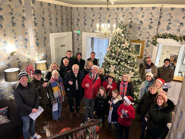 CAROLLERS HELP BRING CHEER TO FOOD BANK