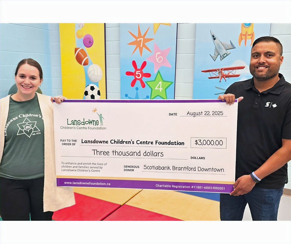Child and Youth Worker Paige Shewfelt (left) joins Scotiabank Business Advisor Chris Dias (right) in the Lansdowne Children's Centre Smilezone Gymnasium for a cheque presentation. Scotiabank Brantford Downtown made a $3,000 donation in support of Lansdowne child and youth programs and services.
