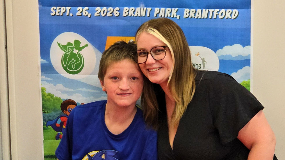 boy in blue t-shirt embraces his mom woman in black dress and glasses