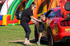 woman helps child to look inside race car window