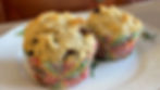 A plate with two flaxseed and prune muffins.