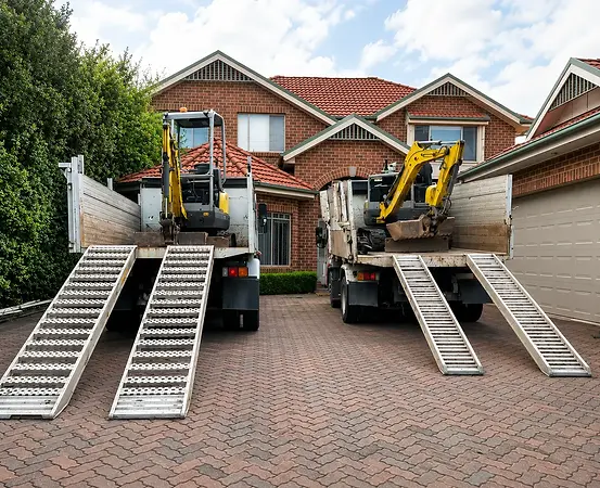 Heavy Duty Enterprises excavators and trucks prepared for excavation and demolition projects across Sydney.