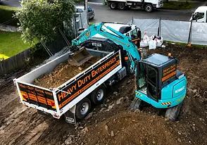 Excavator loading soil into a tipper truck during a soil haulage project in Sydney.