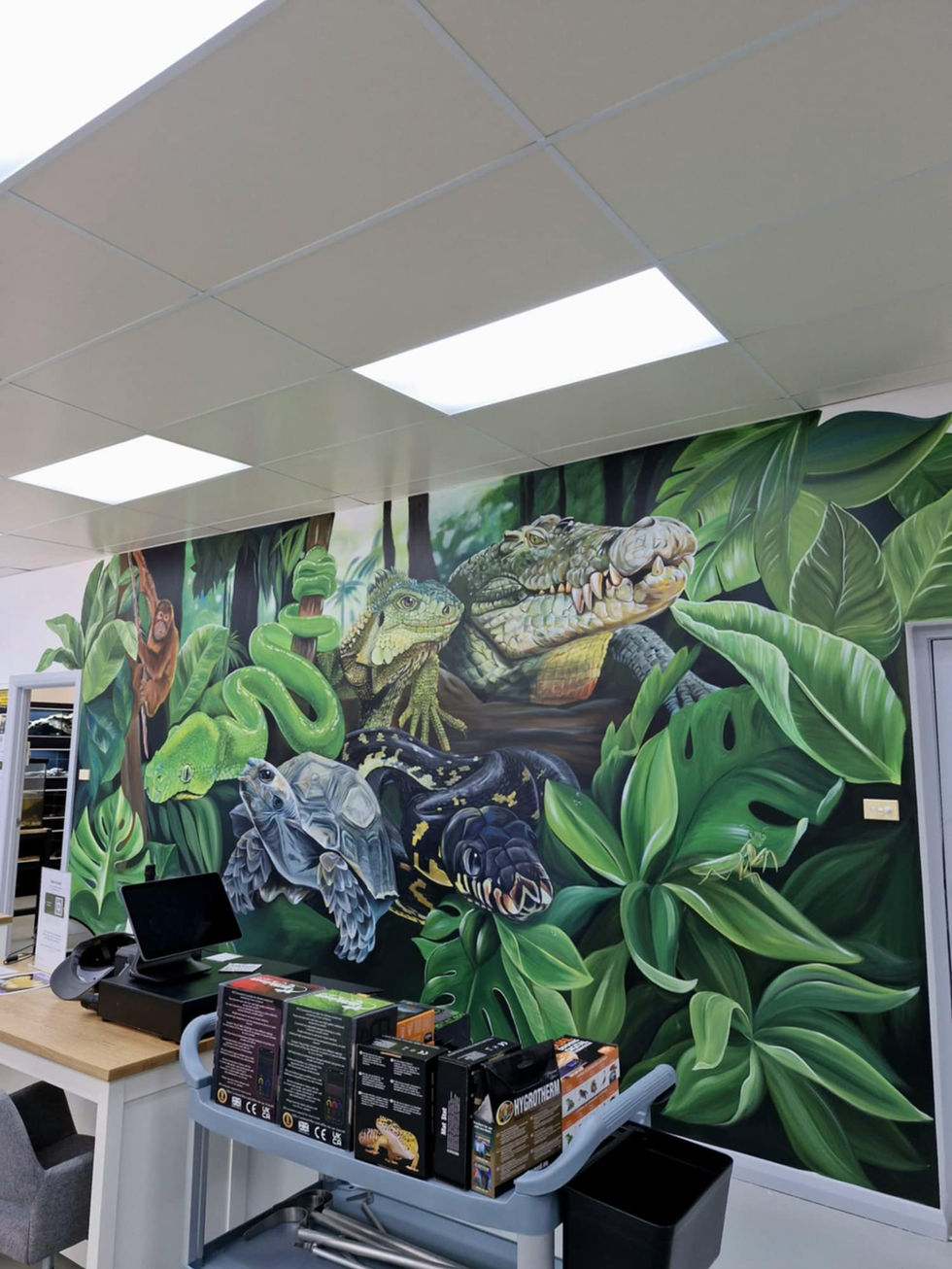 A hand painted, realistic reptile mural