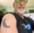 Thomas Ahern showing the tattoo of a bear claw.