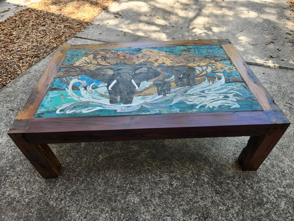 Stone and wood table featuring elephants