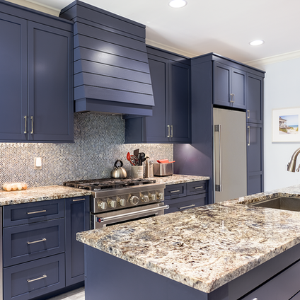 Don't be afraid of color in your kitchen! White cabinetry might be classic, but blue in this galley kitchen adds a touch of sophistication and elegance. It perfectly complements the granite countertops and stainless steel appliances.