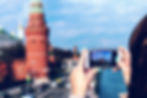 A lady taking a picture of Russian architecture