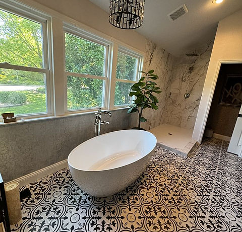 Master bathroom remodel with freestanding tub and patterned tile floor by KCK Construction