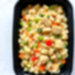 Fried rice with mixed vegetable and diced chicken in a black meal prep container.jpg
