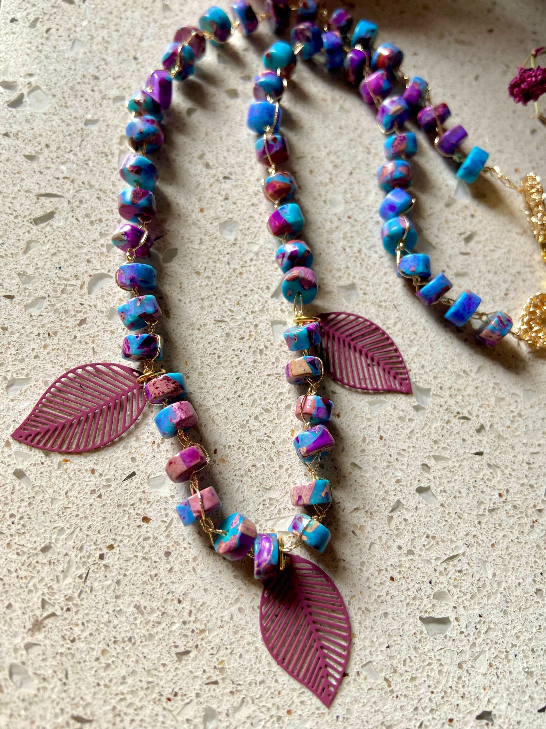 Collana uncinetto con filato prezioso oro e rondelle di pietre dure lapis, con pendenti a foglia smaltate