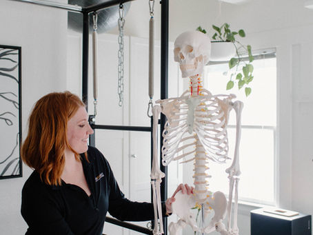 a woman holding the hip of a skeleton