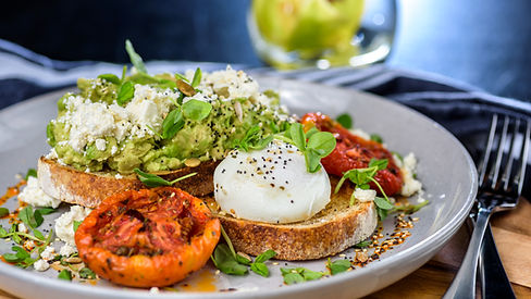 Avocado Toast featuring smashed avocado, grilled tomatoes, boiled egg on sourdough toast.j