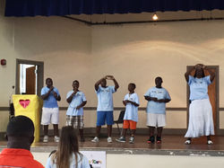 5th and 6th grade boys leading songs in our assembly!