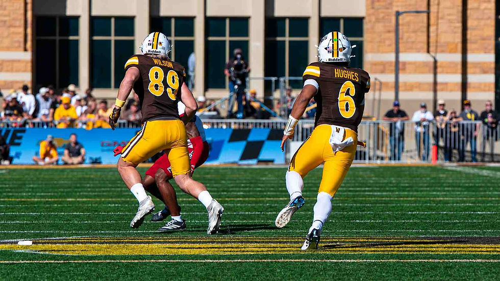 Wyoming tight end Jake Wilson (#89) blocks as quarterback Tyler Hughes (#6) runs with the ball against Northern Illinois at War Memorial Stadium. Photo by Christian Lasher, PokesNews.com.