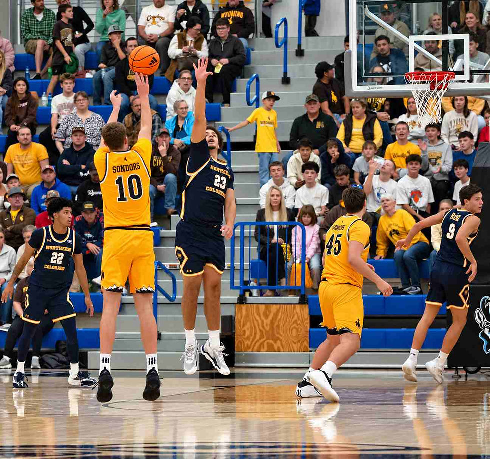 Wyoming forward Renars Sondors (#10) attempts a jump shot over a Northern Colorado defender during an exhibition game in Gillette, Wyoming. Photo by Jeff Bugher, PokesNews.com.