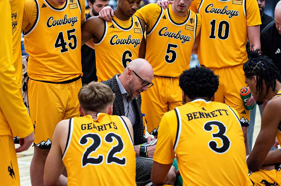 Wyoming head men's basketball coach Sundance Wicks draws up a play during a timeout as Cowboys players gather around him during an exhibition game against Northern Colorado in Gillette, Wyoming. Photo by Jeff Bugher, PokesNews.com.