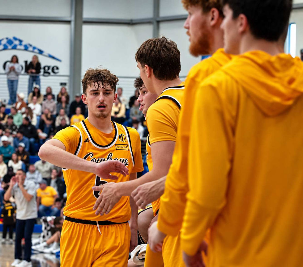 Wyoming guard Madden Smiley (#5) exchanges low fives with teammates near the Cowboys' bench during an exhibition game against Northern Colorado in Gillette, Wyoming. Photo by Jeff Bugher, PokesNews.com.