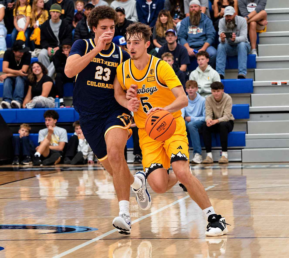 Wyoming guard Madden Smiley (#5) drives past Northern Colorado defender (#23) during an exhibition game in Gillette, Wyoming. Photo by Jeff Bugher, PokesNews.com.
