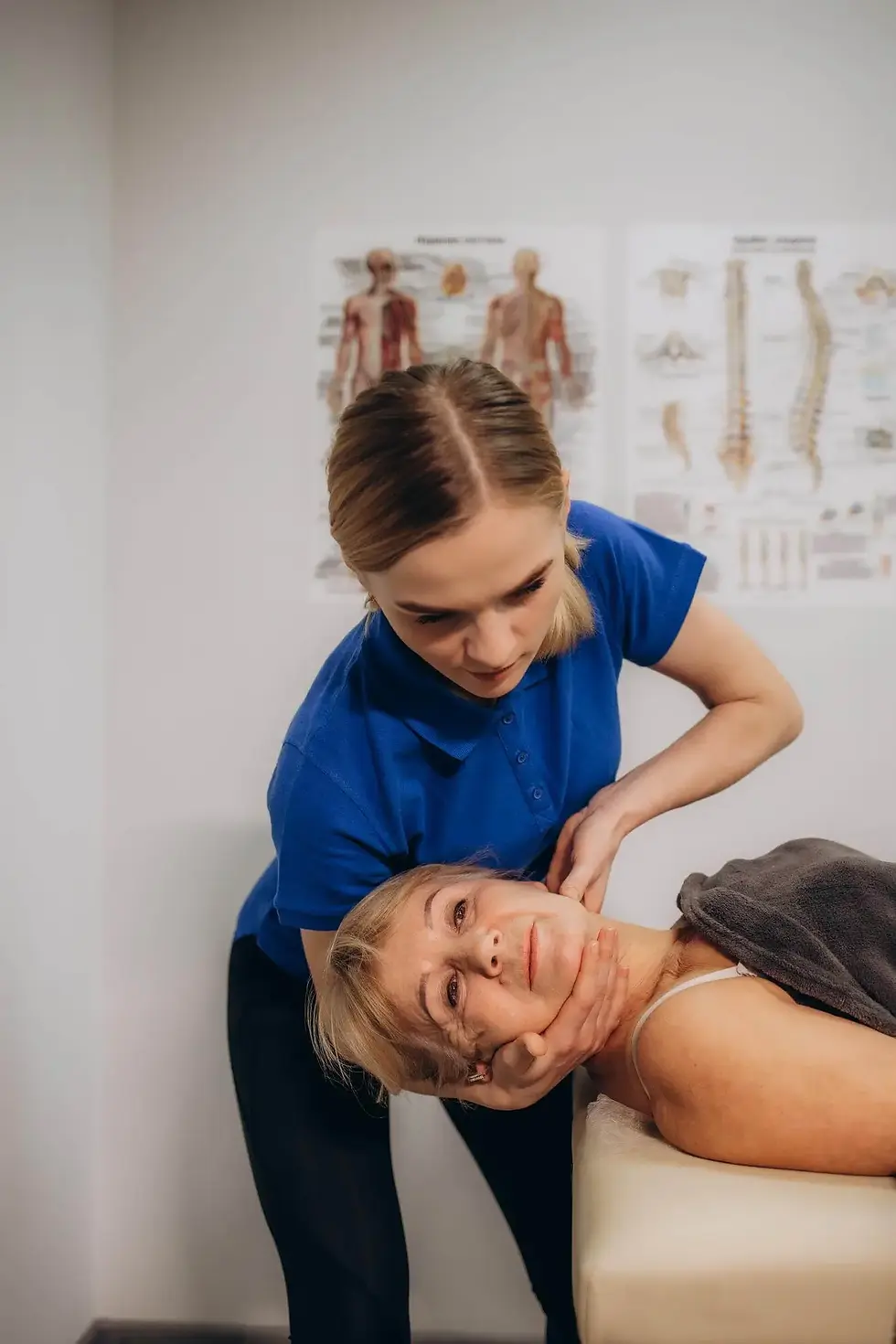 Therapist guiding a patient's head and neck during a repositioning maneuver