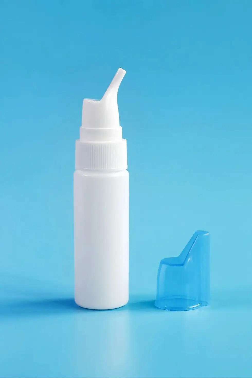 Nasal irrigation bottle with cap on a blue background