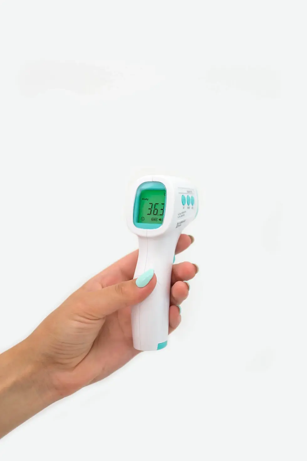 Hand holding a forehead thermometer