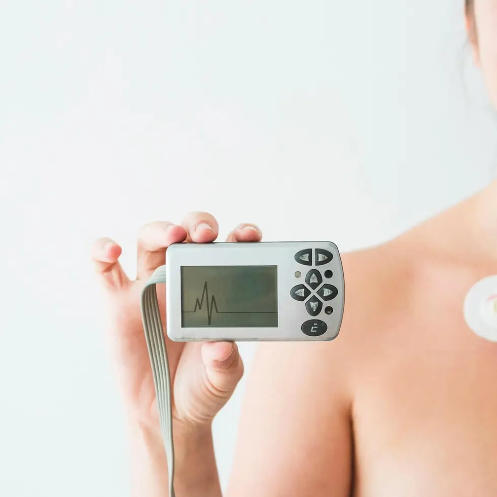 woman-with-electrodes-holding-monitor-with-cardiogram