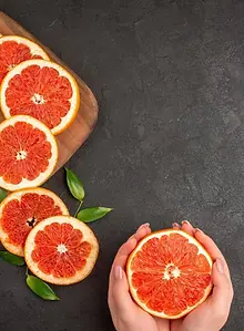 top-view-fresh-grapefruit-slices-dark-background