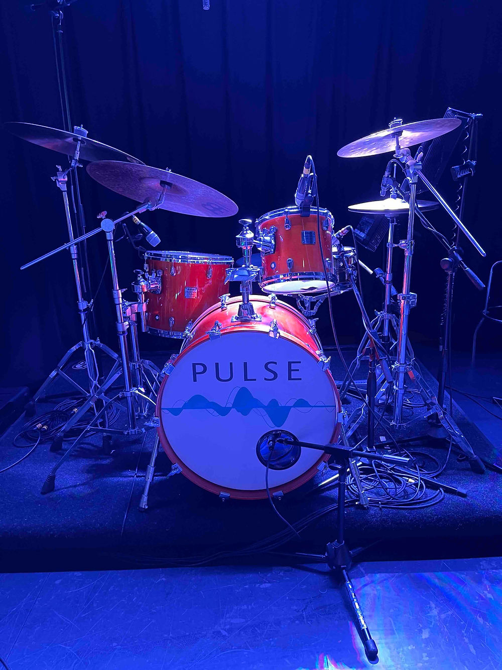 Drum set with 'PULSE' logo