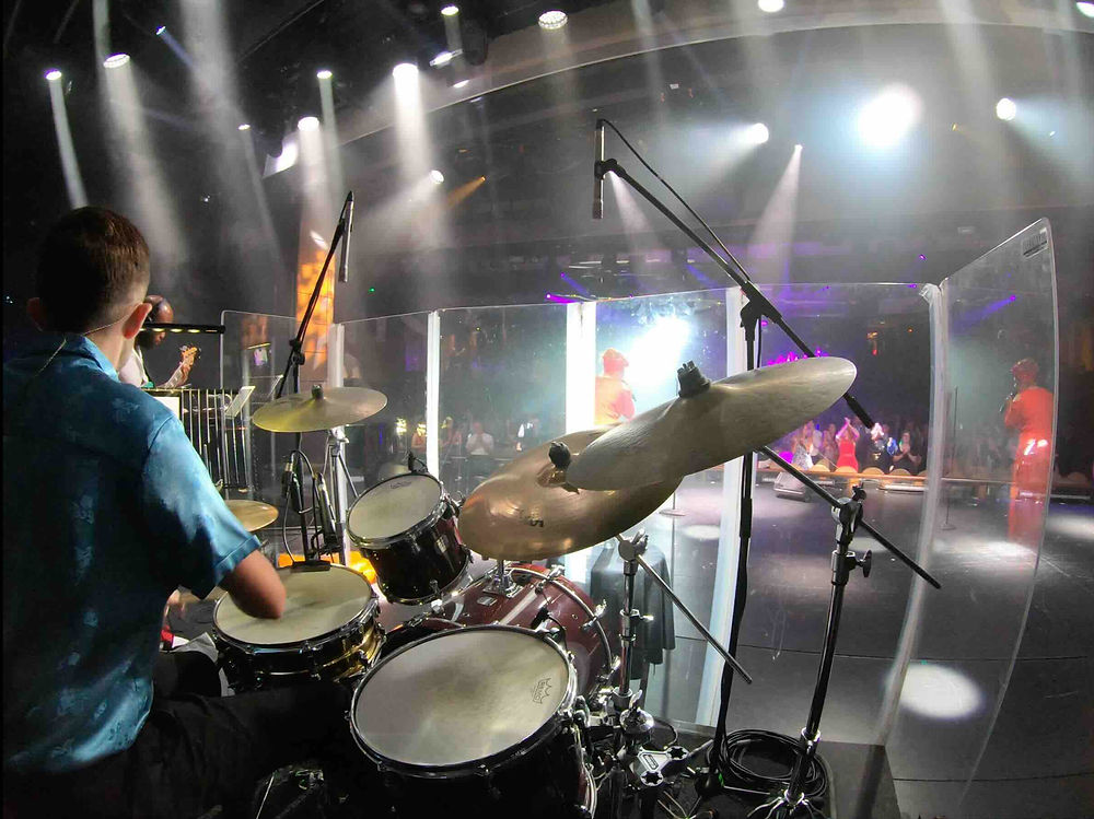 Drummer playing a drum kit on stage