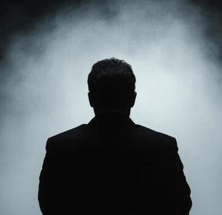 mysterious-silhouette-of-a-businessman-in-a-dramatic-setting-free-photo.jpeg
