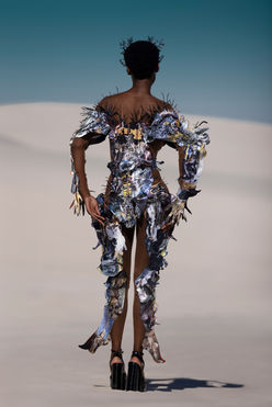 Chelsea Jean Lamm & Ashley Elizabeth Lamm – The Future of Sustainable Avant-Garde Couture
Discover the visionary world of Chelsea Jean Lamm & Ashley Elizabeth Lamm, a high-end couture duo with South African and German roots, redefining wearable art and sustainable luxury fashion. Their avant-garde creations fuse heritage craftsmanship, innovative textile techniques, and cutting-edge materials, making them a rising force in the future of fashion.
Each garment is a masterpiece of sustainability and artistry, featuring reclaimed print media, dead-stock silk, intricate hand embroidery, and experimental fabric manipulation. Chelsea’s couture designs embrace bold silhouettes and sculptural forms, while Ashley’s analogue collage techniques transform discarded materials into layered, textural storytelling.
Their work represents a new era of luxury fashion, where sustainability, innovation, and avant-garde design merge seamlessly. From laser-cut detailing to eco-conscious embellishments, every piece reflects a commitment to modern craftsmanship and ethical production.
For those seeking trendy, high-end, and concept-driven couture, their collections are the epitome of sustainable luxury. Explore their wearable art, statement couture, and fashion-forward designs—crafted for individuals who embrace artistic expression and the evolution of high fashion.
Echoes of Eden 2023 by Chelsea Jean Lamm in collaboration with Ashley Elizabeth Lamm, Look Alligator, modeled by Nondi Beattie from Boss Models, photographed by Nina Zimolong, Mask by Carina Shoshtary, shot in Cape Town, South Africa