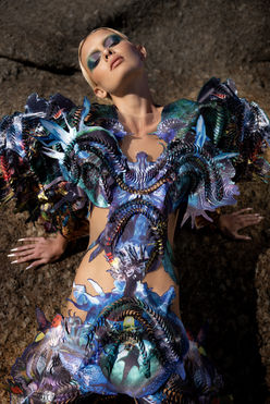 Chelsea Jean Lamm & Ashley Elizabeth Lamm – The Future of Sustainable Avant-Garde Couture
Discover the visionary world of Chelsea Jean Lamm & Ashley Elizabeth Lamm, a high-end couture duo with South African and German roots, redefining wearable art and sustainable luxury fashion. Their avant-garde creations fuse heritage craftsmanship, innovative textile techniques, and cutting-edge materials, making them a rising force in the future of fashion.
Each garment is a masterpiece of sustainability and artistry, featuring reclaimed print media, dead-stock silk, intricate hand embroidery, and experimental fabric manipulation. Chelsea’s couture designs embrace bold silhouettes and sculptural forms, while Ashley’s analogue collage techniques transform discarded materials into layered, textural storytelling.
Their work represents a new era of luxury fashion, where sustainability, innovation, and avant-garde design merge seamlessly. From laser-cut detailing to eco-conscious embellishments, every piece reflects a commitment to modern craftsmanship and ethical production.
For those seeking trendy, high-end, and concept-driven couture, their collections are the epitome of sustainable luxury. Explore their wearable art, statement couture, and fashion-forward designs—crafted for individuals who embrace artistic expression and the evolution of high fashion.
Look Anemone, Echoes of Eden 2023 by Chelsea Jean Lamm in collaboration with Ashley Elizabeth Lamm, modeled by Max Penny from Kult Models, photographed by Nina Zimolong in Cape Town, South Africa