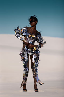 Chelsea Jean Lamm & Ashley Elizabeth Lamm – The Future of Sustainable Avant-Garde Couture
Discover the visionary world of Chelsea Jean Lamm & Ashley Elizabeth Lamm, a high-end couture duo with South African and German roots, redefining wearable art and sustainable luxury fashion. Their avant-garde creations fuse heritage craftsmanship, innovative textile techniques, and cutting-edge materials, making them a rising force in the future of fashion.
Each garment is a masterpiece of sustainability and artistry, featuring reclaimed print media, dead-stock silk, intricate hand embroidery, and experimental fabric manipulation. Chelsea’s couture designs embrace bold silhouettes and sculptural forms, while Ashley’s analogue collage techniques transform discarded materials into layered, textural storytelling.
Their work represents a new era of luxury fashion, where sustainability, innovation, and avant-garde design merge seamlessly. From laser-cut detailing to eco-conscious embellishments, every piece reflects a commitment to modern craftsmanship and ethical production.
For those seeking trendy, high-end, and concept-driven couture, their collections are the epitome of sustainable luxury. Explore their wearable art, statement couture, and fashion-forward designs—crafted for individuals who embrace artistic expression and the evolution of high fashion.
Echoes of Eden 2023 by Chelsea Jean Lamm in collaboration with Ashley Elizabeth Lamm, Look Alligator, modeled by Nondi Beattie from Boss Models, photographed by Nina Zimolong, Mask by Carina Shoshtary, shot in Cape Town, South Africa