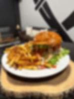 Handcrafted cheeseburger topped with melted cheese and served with crispy fries at Wicked Axe.