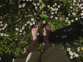 Walking barefoot on grass while breathing consciously