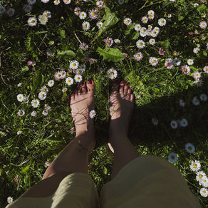Walking barefoot on grass while breathing consciously