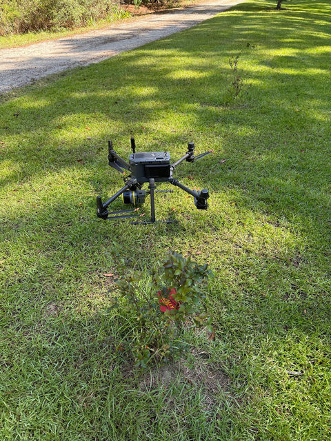A survey drone on a mowed grass strip before flight