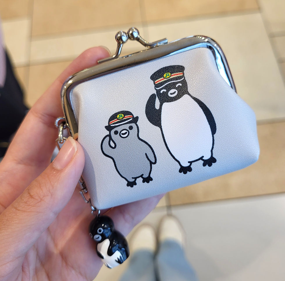a girl holding a coin purse with a cute design in Tokyo, Japan