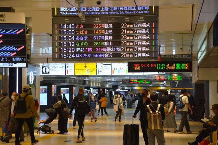 People walking in different directions at a Shinkansen bullet train station in Japan
