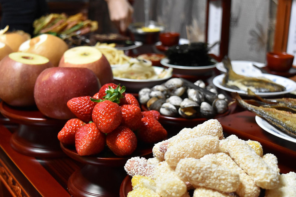 Apples, strawberries, sweets, and other foods placed as offerings on an altar