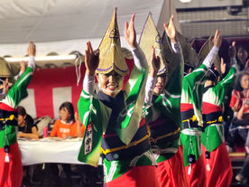 girls dressed in traditional Japanese clothes performing an Awa Odori dance during a summer festival in Tokyo, Japan