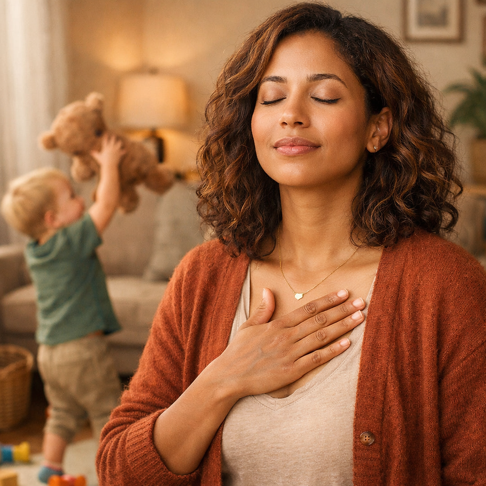 Woman meditating with eyes closed, hand on chest, in living room. Child plays with teddy bear in background. Warm lighting, calm mood.