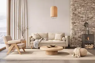 Warm, minimalist living room with wood, neutral tones and fireplace,