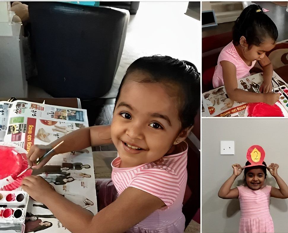 Online preschool student finishes her community helpers craft.