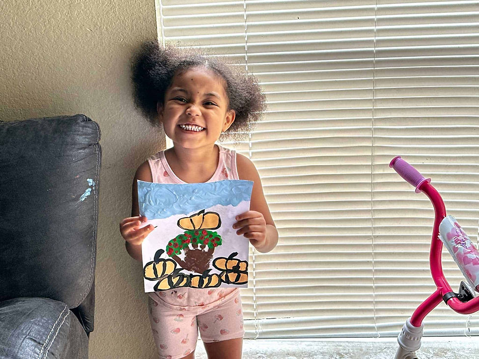 online preschool student Ahri shows us her fall project at Creative Kids Virtual Preschool