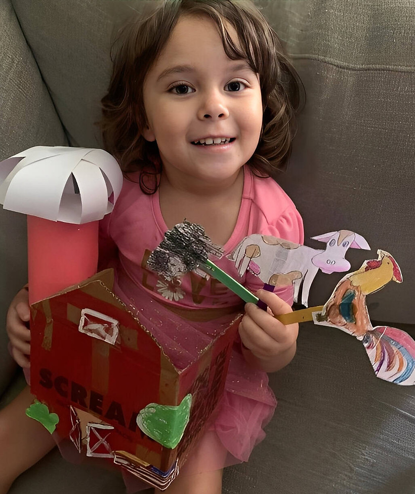 Olivia shows off her online preschool project for Farms theme.